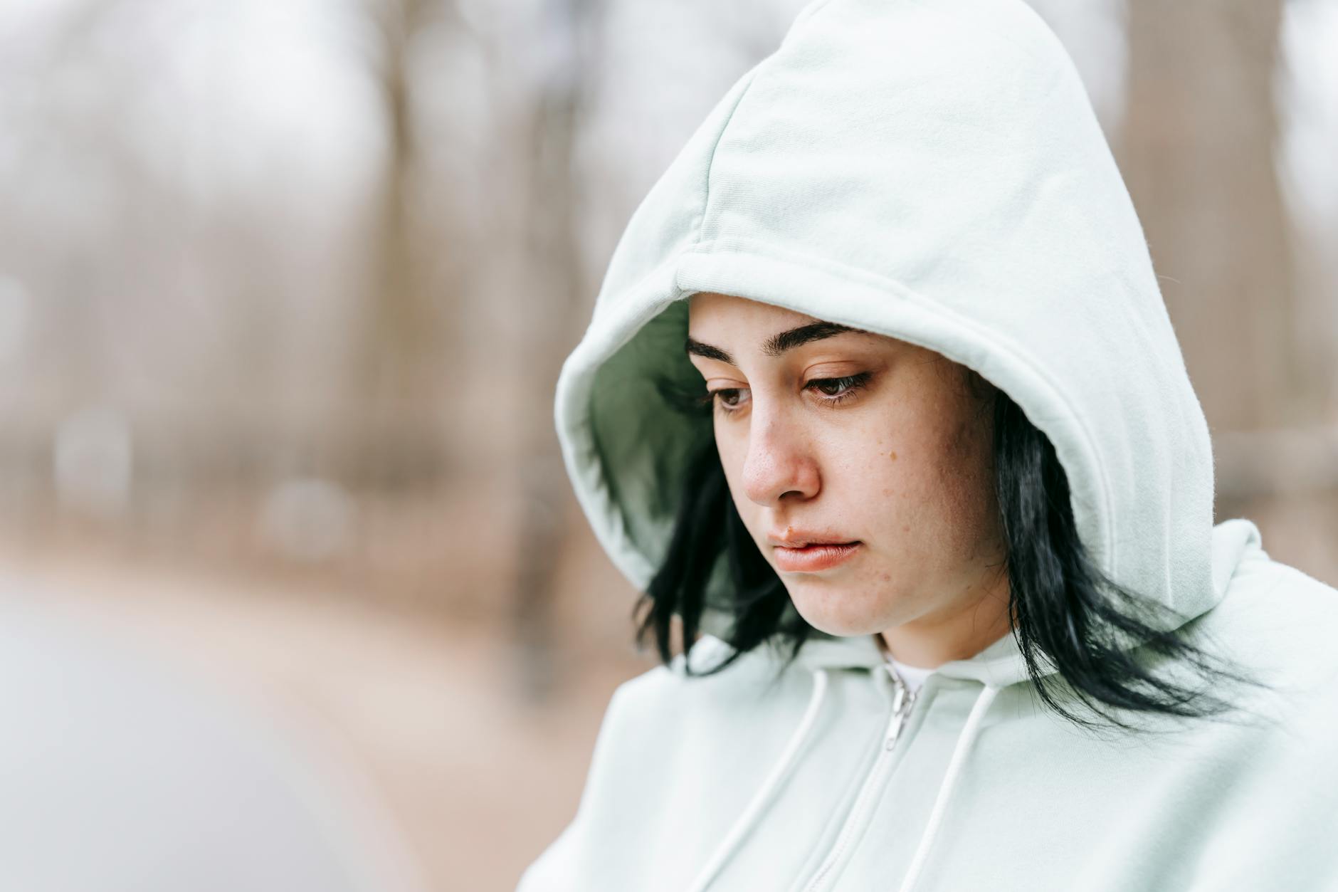 upset lady sitting in park and thinking