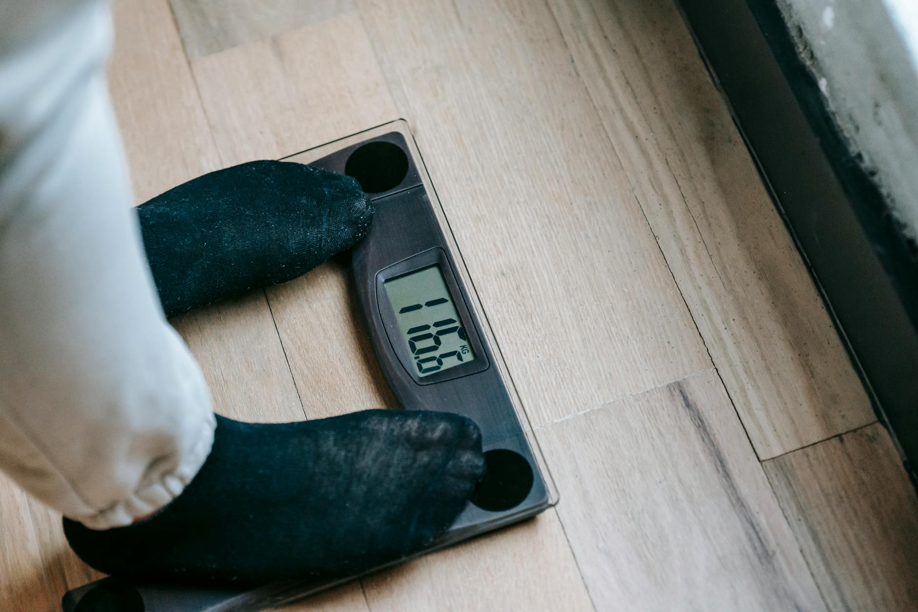 crop person on weight scales